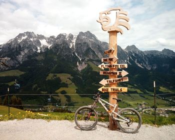 View of cross on landscape against mountains