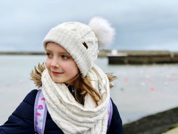 Close-up of girl wearing warm clothing against sea