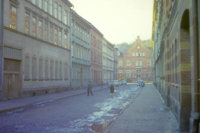 Street amidst buildings against sky in city