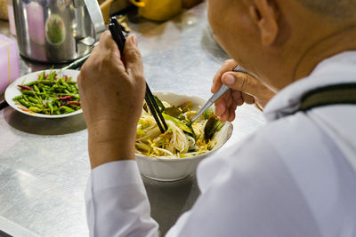 Midsection of man having food