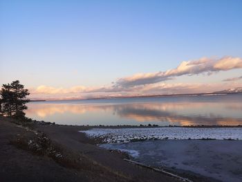 Scenic view of beach against sky during sunset