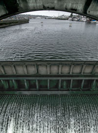 Bridge over river during winter