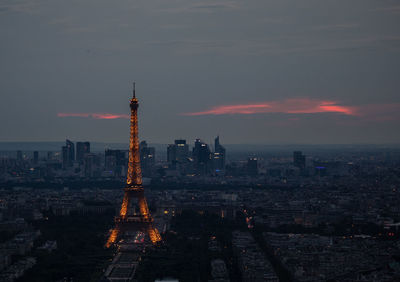 Aerial view of buildings in city at sunset