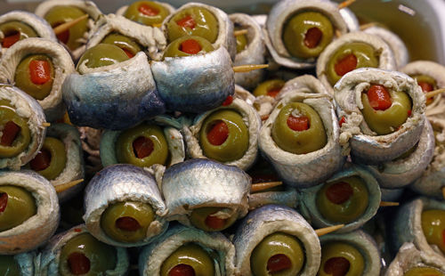 High angle view of anchovy rolls with olives