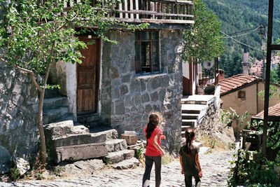 Two kids walking on the village road