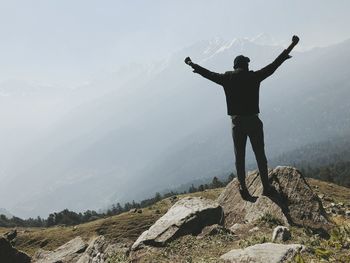 Full length of man standing on mountain during foggy weather