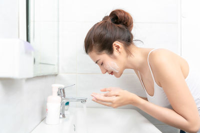 High angle view of young woman in bathroom