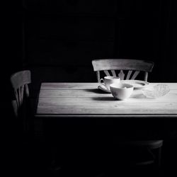 Empty chairs in dark room