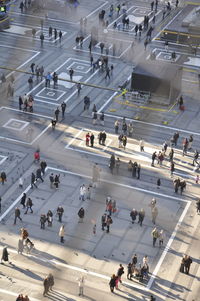 High angle view of people walking on road in city