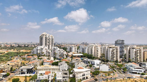 High angle view of buildings in city against sky