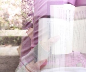 Midsection of woman holding paper at home