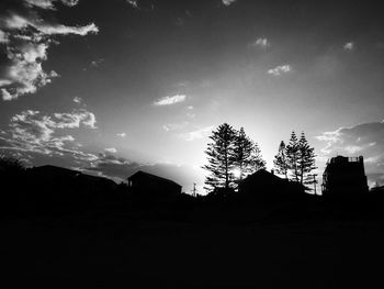 Low angle view of silhouette trees against sky