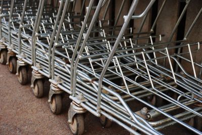 Close-up of shopping carts arranged on footpath