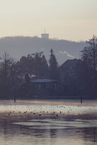 Scenic view of lake against sky during winter