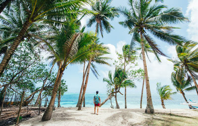 Man standing on shore at beach