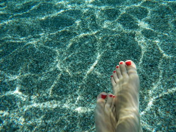 Low section of woman legs in sea