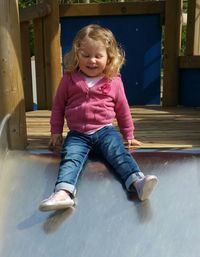 Full length of girl playing on slide at park