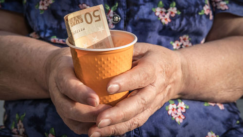 Close-up of hand holding drinking glass