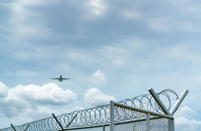 Low angle view of airplane flying against sky