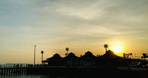 Silhouette of people at beach during sunset