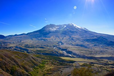 Scenic view of mountains against clear blue sky