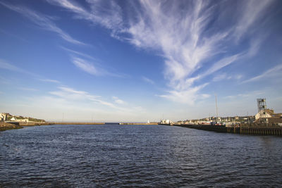 View of sea against buildings in city