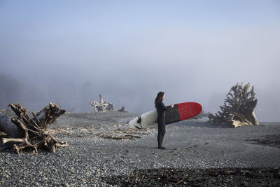 Beautiful, fit surfer girl in the pacific northwest