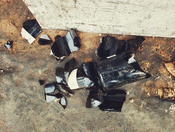 High angle view of old shoes on wall