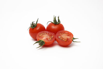 Close-up of tomatoes over white background