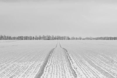 Tire tracks on snow covered field