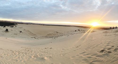 Scenic view of beach against sky during sunset