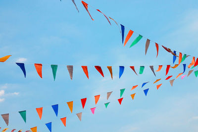 Low angle view of flags against sky