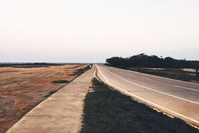 Empty road against clear sky