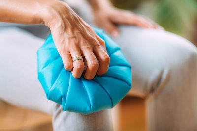 Knee pain treatment. woman holding an ice bag pack on her painful knee