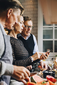 Friends and woman having food at table