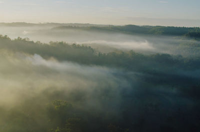 Scenic view of fog covered landscape against sky