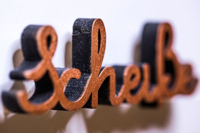 Close-up of text on metal against white background