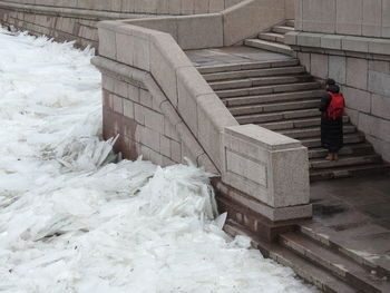 High angle view of man standing on staircase during winter