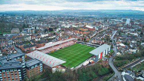 High angle view of townscape against sky, featuring a sport stadium 