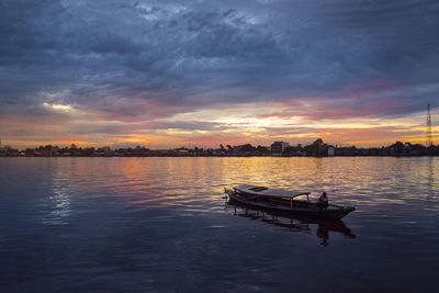 Scenic view of lake against sky during sunset