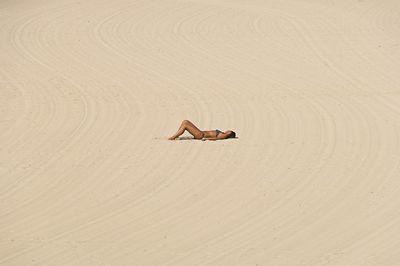 Woman lying on sand