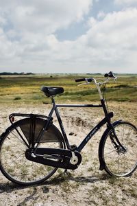 Bicycle on field against sky
