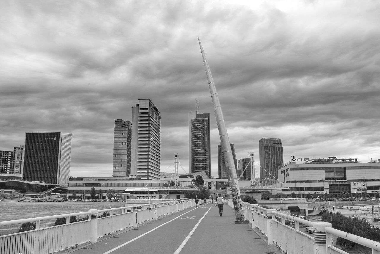 architecture, sky, built structure, building exterior, cloud - sky, cloudy, city, skyscraper, modern, cloud, the way forward, overcast, weather, city life, cityscape, transportation, tall - high, street, office building, road