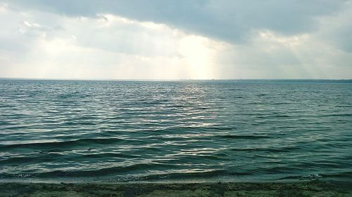 View of calm sea against cloudy sky