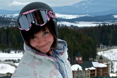 Portrait of smiling beautiful woman wearing skiing helmet