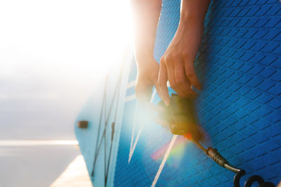 Cropped image of man holding umbrella