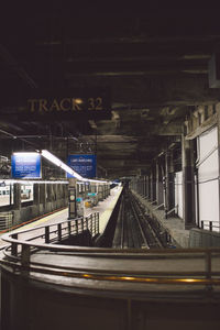 Illuminated railroad station in city at night