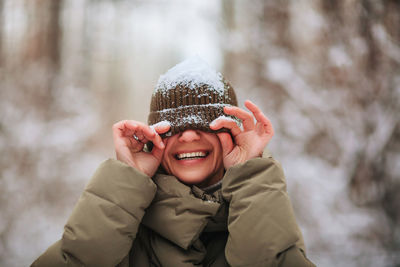 Portrait of smiling girl with snow during winter