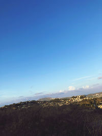 Scenic view of land against blue sky