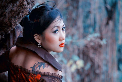 Close-up of beautiful young woman looking away